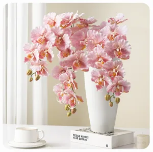 Artificial pink phalaenopsis orchid flower bouquet in white vase for home decor detail.