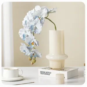 Artificial orchid flower branch detail shot, elegant blue phalaenopsis for home decor and vase.