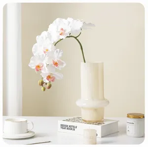 Artificial 9-head Phalaenopsis orchid flower arrangement in glass vase for home decor.