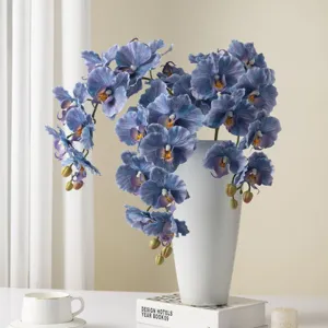 Artificial blue phalaenopsis orchid flowers in white vase for home decor and photography.