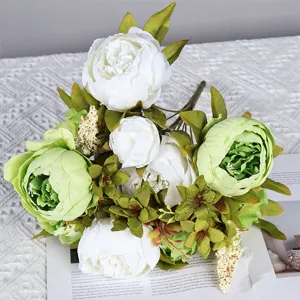 Vue rapprochée du bouquet de fleurs de pivoine artificielle avec des feuilles vertes pour la maison.