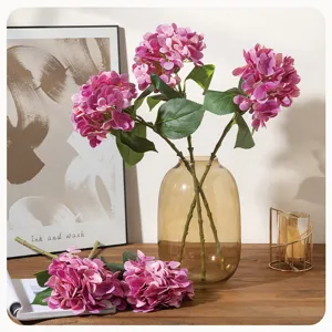 Artificial hydrangea flower branches in a glass vase, perfect for home and wedding decor.
