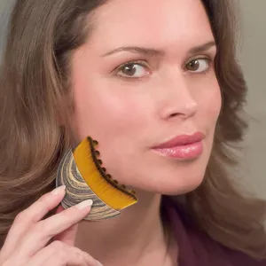 Contour face brush detail view, showing ergonomic handle and dense bristles for makeup application.