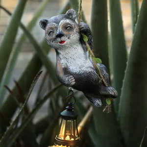 Solar climbing raccoon outdoor statue with hanging LED lantern for garden decor main view