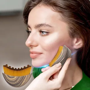 Lymphatic contour face brush with wood grain handle and dense yellow bristles for facial massage.