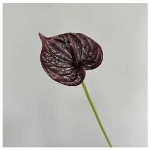 Close-up detail of dark red artificial anthurium flower, realistic PU texture for decor.