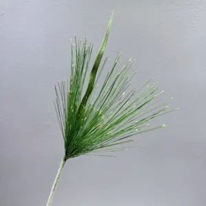 Artificial plant detail closeup, realistic green fountain grass branch for wedding floral decor.