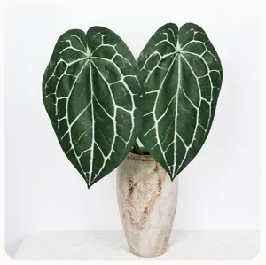 Artificial crystal anthurium leaf detail shot, vibrant green foliage with white veins in vase.