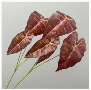 Artificial dark leaf close-up, purple artificial alocasia foliage for floral design.