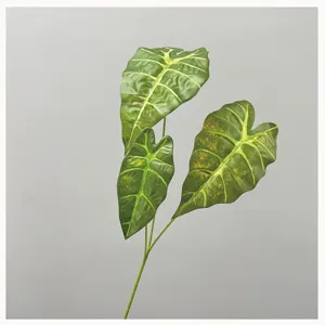 Close-up of artificial alocasia leaf branch with realistic veins and texture details.