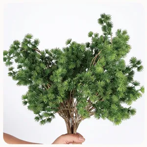 Close-up detail of artificial pine branch bundle, lush green pine needles for decor.