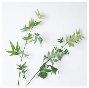 Detailed close-up view of artificial bamboo leaves, fake green plant branches for Zen decor.