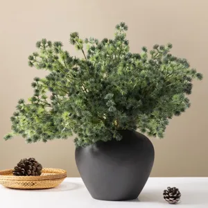 Artificial pine branches in black vase for home decor, beautiful green plant bouquet.