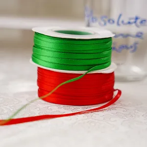 Red and green double-sided polyester ribbon for gift wrapping, crafts, and decoration details.