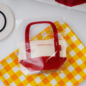 Clear plastic cookie packaging bag with red handle portable gift pouch for baking treats.