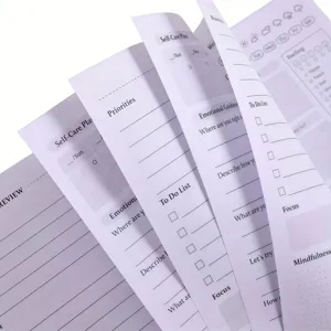 Detailed view of self-care planner inner pages layout, mental health tracking sections.