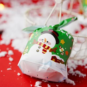 Detailed shot of Christmas snowman candy packaging bag, festive green plastic gift pouch.