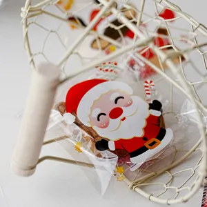 Detail view of a clear self-adhesive plastic candy bag with cute Santa Claus print for pastries.
