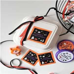 Detailed close-up view of Halloween square stickers, decorative box and festive party props.
