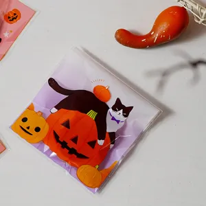 Halloween themed transparent cookie and gift packaging bag with cute black cat and pumpkin art.
