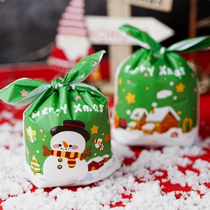 Christmas candy gift packaging bags with cute snowman print and rabbit ear ties for holiday decor.