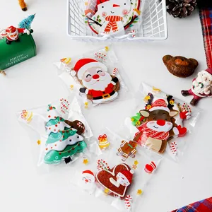 Detail view of Christmas self-adhesive candy packaging bags with cute Santa and tree designs.