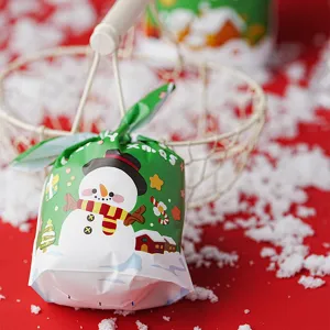 Christmas candy packaging bag detail view, green plastic pouch with cute snowman design.