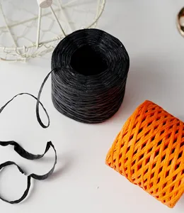 Paper twine detail shot showing black and orange rolls and string for DIY gift wrapping.