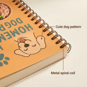 Close-up of spiral-bound pet recipe notebook featuring cute dog illustration and metal coil.