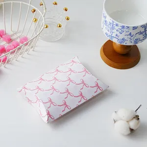 Pink bow pillow gift box featuring a cute grid pattern, ideal for wrapping delicate cookies.