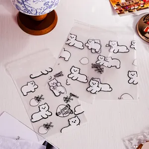 Frosted self-adhesive plastic bags with cute cartoon bear designs for sweet gift packaging.