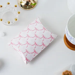 Pink bow pillow box detail view, aesthetic grid pattern paper packaging for gifts and cookies.