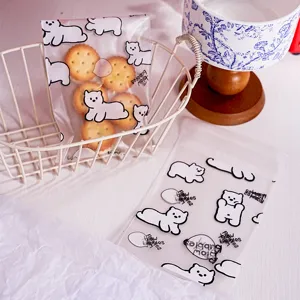 Transparent self-sealing packaging bags with cute cartoon bear print for cookies and snacks.