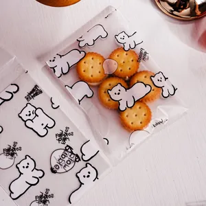 Clear plastic self-sealing packaging bags with cute white bear cartoon prints, perfect for cookies.