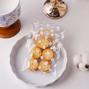 Clear self-adhesive cookie packaging bags with white polka dots design for gift packing detail.