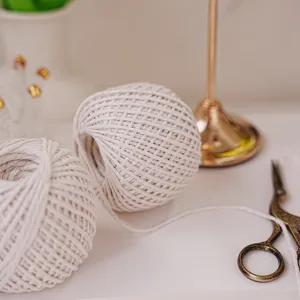 Close-up detail of white cotton string yarn ball for DIY handmade packaging and crafts design.