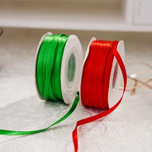 Red and green polyester ribbon detail view, ideal for gift wrapping and decorative crafts.