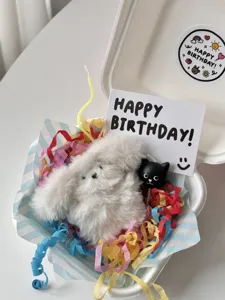 Detail view of cute happy birthday cartoon stickers and gift box packaging set for parties.