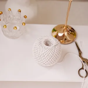 Closeup of white cotton twine ball, perfect for DIY crafts and gift wrapping details.