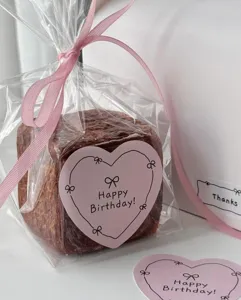 Pink heart sticker with hand-drawn bow design, ideal for gift wrapping, diary, and party decor.