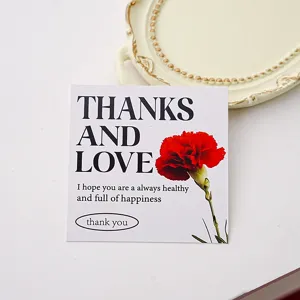 Detail view of Mother's Day greeting card with red carnation flower and thank you text.