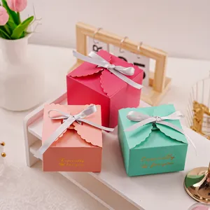 Detailed scene view of colorful gift boxes with silver ribbons and gold stamped lace edges.