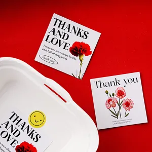 Detailed view of Mother's Day greeting cards with carnation floral prints and warm wishes.
