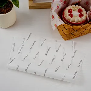 Greaseproof baking paper detail showing stacked sheets with hand made print and food styling.