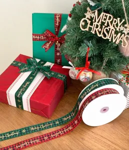 Christmas ribbon detail showcasing the metallic gold snowflakes and plaid pattern on spool.