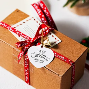 Detailed shot of Christmas gift box with heart tag, red ribbon, and bell. Festive DIY decor.