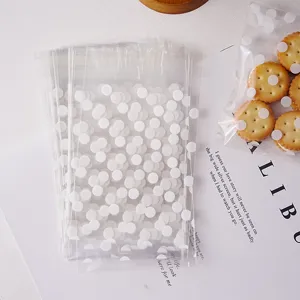 Detailed close-up of clear self-adhesive cellophane bags with cute white polka dot patterns.