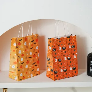Close up detail of Halloween paper gift bags featuring cute pumpkin and ghost patterns.
