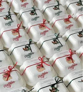 Disposable Christmas burger boxes with festive wrappers and ribbons, ideal for holiday party treats.