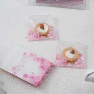 Frosted cookie bags with pink cherry blossom design, self-adhesive plastic gift packaging.